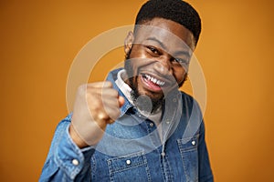 Happy excited african american young man celebrating success