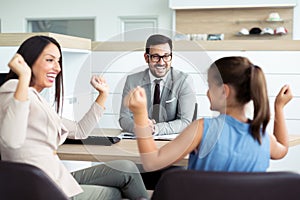 Happy and excited family celebrating just bought a new car from dealership photo