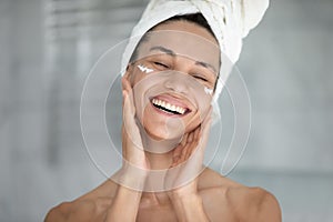 Happy excited beautiful girl enjoying facial skincare procedures