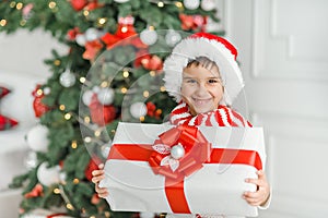 Happy excited child holding christmas gift box