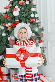 Happy excited child holding christmas gift box