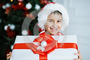 Happy excited child holding christmas gift box