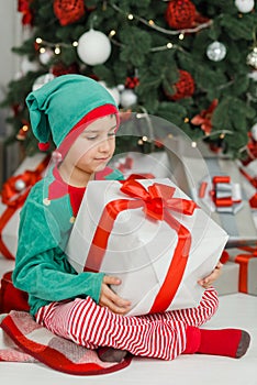 Happy excited child holding christmas gift box