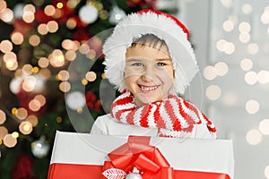 Happy excited child holding christmas gift box