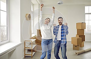 Happy, excited family couple having fun while moving into new house or apartment