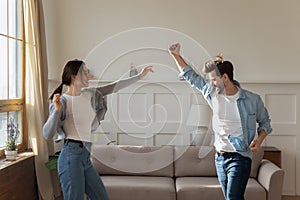 Happy excited family spouses dancing to favorite music.