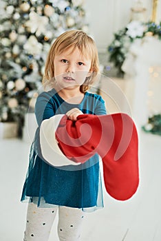 Happy excited girl child holding christmas candy canes. Happy little girl excited at Christmas Eve.