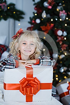 Happy excited girl child holding christmas gift box