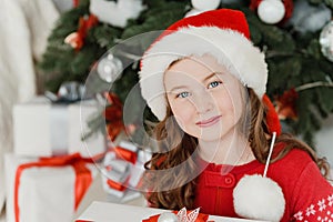 Happy excited girl child holding christmas gift box