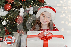 Happy excited girl child holding christmas gift box
