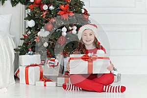 Happy excited girl child holding christmas gift box