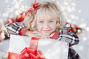 Happy excited girl child holding christmas gift box