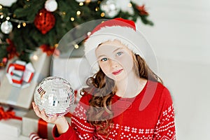 Happy excited girl child holding christmas gift box