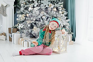 Happy excited girl child holding christmas gift box