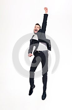 Happy excited handsome young businessman jumping and celebrating success
