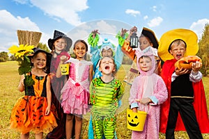 Happy excited kids in Halloween costumes