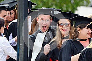 Happy excited university students graduating graduation day