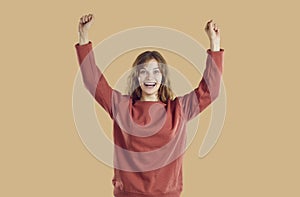 Happy excited woman celebrating victory, raising her hands up, smiling and cheering