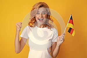 Happy excited woman holding flag of Germany, immigration and travelling in Europe. Deutschland, deutsche flag. Germany