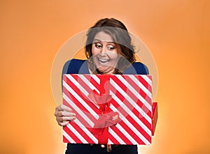 Happy excited woman opening red gift box