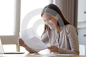 Happy excited woman reading letter with good news, great offer