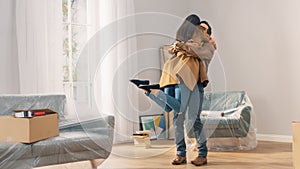 Happy and Excited Young Couple Look Around In Wonder at their Newly Purchased / Rented Apartment