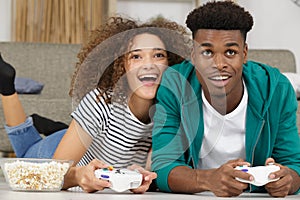 Happy excited young couple playing videogames