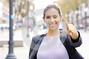 Happy executve pointing at camera in the street