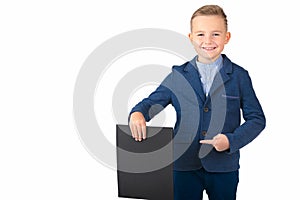 Happy exited caucasian young boy showing and displaying blank black board ready for your text or product