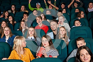 Happy,exited children sitting in the cinema.