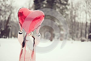 Happy exited girl with Valentine heart balloons outdoor. Valentine`s day concept. Copy space.