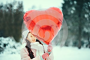 Happy exited girl with Valentine heart balloons outdoor. Valentine`s day concept. Copy space.