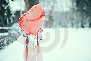 Happy exited girl with Valentine heart balloons outdoor. Valentine`s day concept. Copy space.