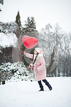 Happy exited girl with Valentine heart balloons outdoor. Valentine`s day concept. Copy space.