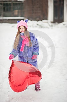 Happy exited girl with Valentine heart balloons outdoor. Valentine`s day concept. Copy space.