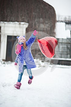 Happy exited girl with Valentine heart balloons outdoor. Valentine`s day concept. Copy space.