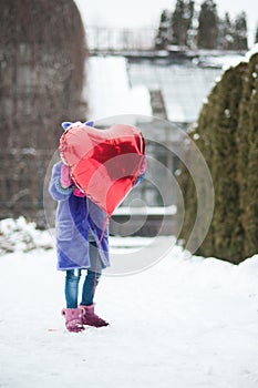 Happy exited girl with Valentine heart balloons outdoor. Valentine`s day concept. Copy space.