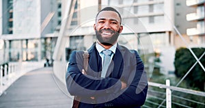 Happy, face and businessman with arms crossed at office building for new job, opportunity or dream career with