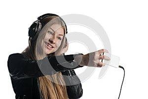 Happy face of a girl in wired headphones making a grimace