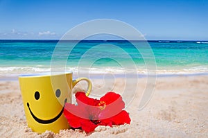 Happy face mug with red hibiscus on the beach