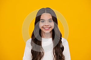 Happy face, positive and smiling emotions of teenager girl. Portrait of beautiful happy smiling teenage girl on yellow