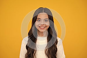 Happy face, positive and smiling emotions of teenager girl. Portrait of beautiful happy smiling teenage girl on yellow