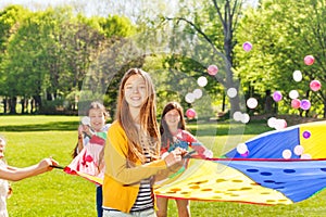 Happy fair-haired girl playing active game outside