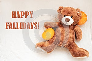 Happy Fallidays, text with soft toy teddy bear and pumpkin