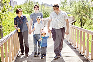 Happy famHappy family spending time outdoors on a Sunny summer day. mom, dad ,grandma and two boys