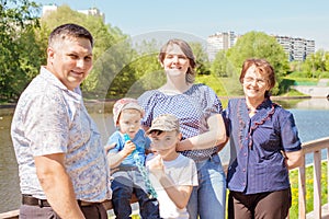 Happy famHappy family spending time outdoors on a Sunny summer day. mom, dad ,grandma and two boys