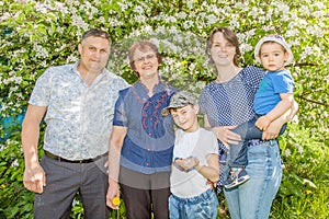 Happy famHappy family spending time outdoors on a Sunny summer day. mom, dad ,grandma and two boys