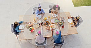 Happy family, above and birthday party in garden with love, sharing and eating to bond together for lunch. Generations