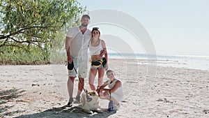 Happy family with Akita Inu standing by the sea