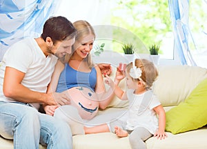Happy family in anticipation of baby. Pregnant mother, father an photo